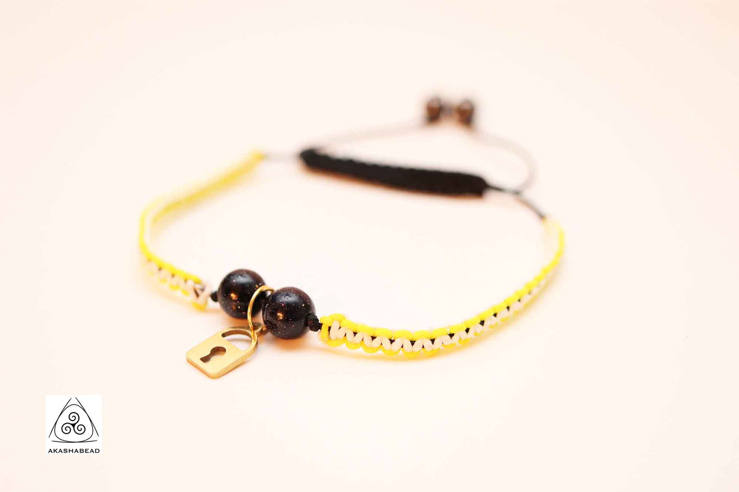 Braided yellow-white with gold color lock charm and sparkly onyx stone  | 8mm